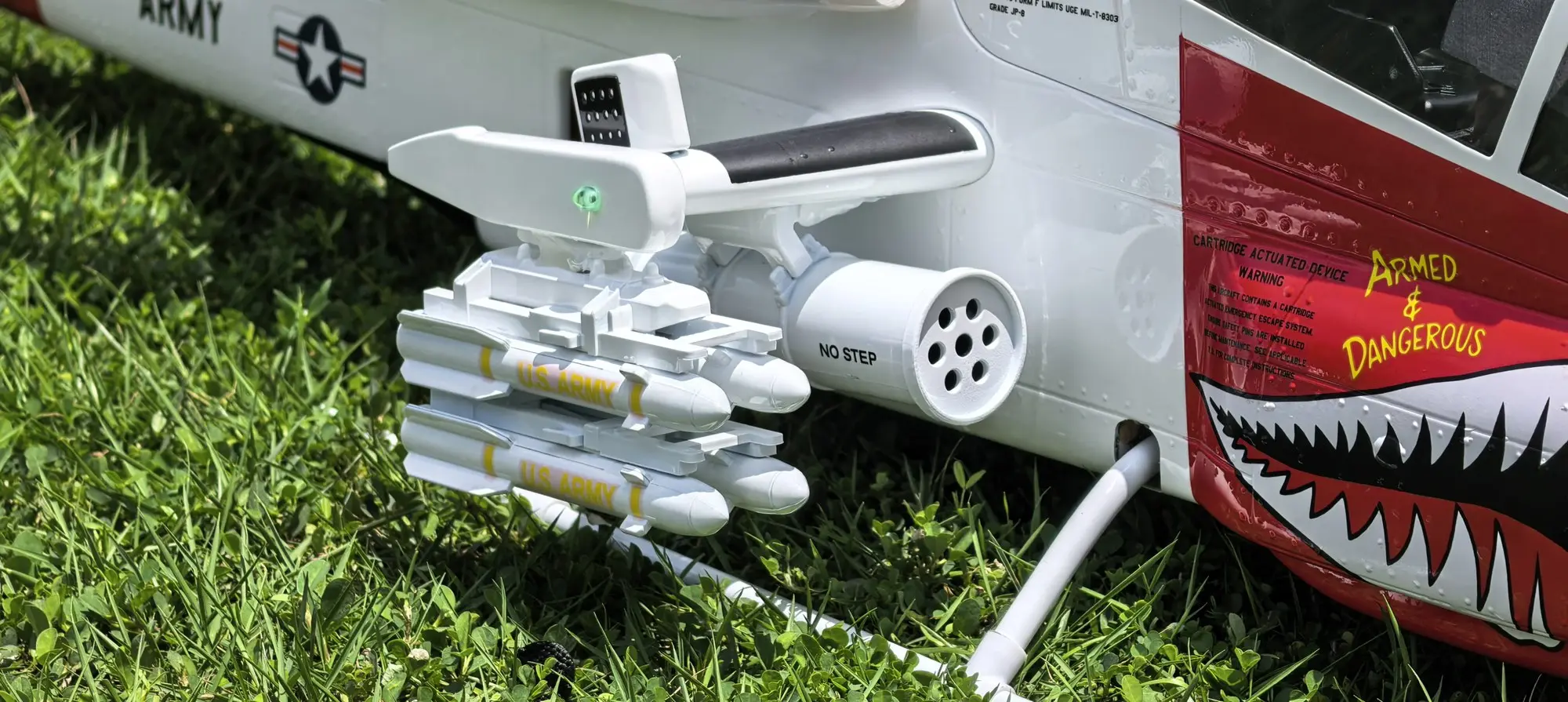 Scale rocket pods and stub wing detail on the FLISHRC AH-1 Cobra white and red RC helicopter
